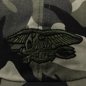 Detailed macro view of the Navy Seals trident embroidery on grey camo tactical hat