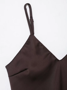 Detail of deep brown satin dress with adjustable thin shoulder strap and V-neckline
