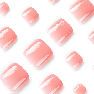 Pink gradient press-on toenails with glitter and high-gloss jelly finish on white background