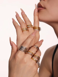 Macro shot of interlocking tri-color mixed metal rings with cubic zirconia pave settings