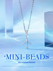 Detail of s925 silver airplane mini charm pendant with polished metal texture