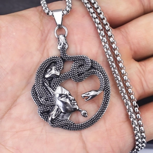 Hip-hop Medusa snake head pendant necklace in vintage silver finish held in hand