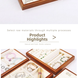 Detailed view of wood jewelry tray with velvet compartments for rings and necklaces