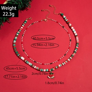 Christmas two-piece colorful beaded necklace set with pearls and bell charms on red background