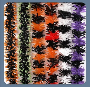 Detail of colorful Halloween tinsel garlands in black, orange, and purple festive colors