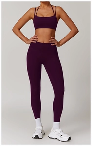 Detail of high-waist quick-dry yoga pants and sports top in dark purple set