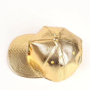 Close-up of golden faux leather snapback hat with metallic snakeskin texture and flat brim