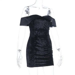 Detail of the black velvet off-shoulder mini dress with elegant slim fit and soft texture