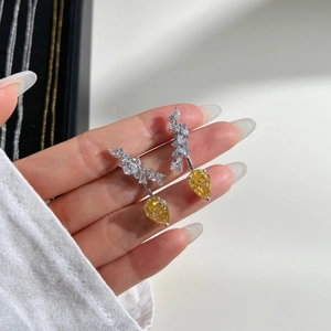 Close-up of S925 silver earring with a yellow pear-shaped drop and marquise zircon stones