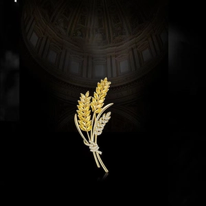 Detailed view of gold wheat ear brooch with sparkling yellow and white crystals