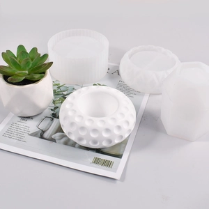 Detail of four geometric silicone molds for DIY succulent pots and textured candle holders