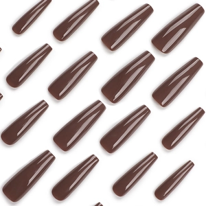 Glossy deep brown extra-long ballerina false nails in a neat array on white background