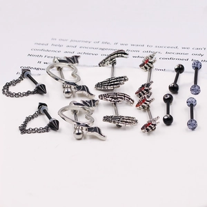 Detailed close-up of gothic nipple ring set with bat, heart, and skull designs