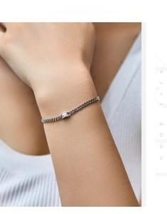 Detailed close-up of s925 silver bracelet with emerald-cut zirconia on a wrist