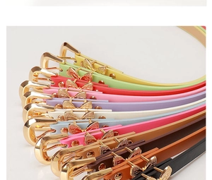 Close-up of colorful leather belts featuring gold butterfly buckles and metal loops