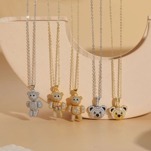 Detail of five teddy bear pendants with zircon crystals and pearls on gold plated chains