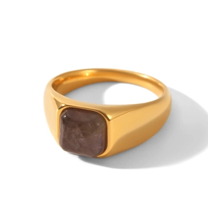 Detailed close-up of a gold stainless steel ring with a square purple-brown gemstone inlay