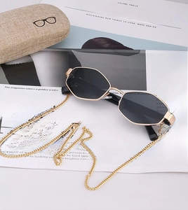 Polished gold metal sunglasses with dark grey lenses and matching decorative chain
