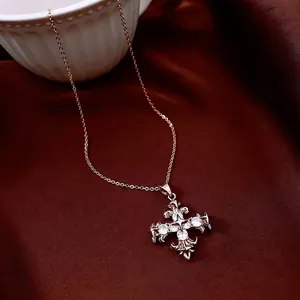Baroque retro rose gold cross necklace with white zircon on red velvet background