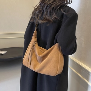 Retro brown suede dumpling bag with a shoulder strap shown on a model for commute