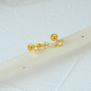 Detailed close-up of three golden S925 silver flat back studs with geometric crystals