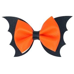 Detail of Halloween bat bow hair clip with black and orange faux leather textures