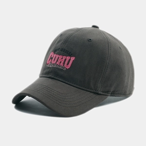 Detail of pink embroidered CUHU letters on a dark grey cotton twill baseball cap