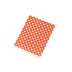 Sheet of yellow smiley face star stickers on red background for school student rewards