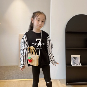 Cute kids strawberry straw crossbody bag paired with casual black streetwear outfit