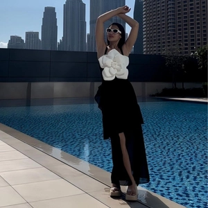 Classic black and white one-piece swimsuit with a large 3D white camellia flower decoration