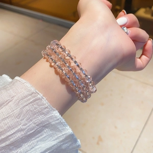 Detail of three-layer champagne crystal beaded bracelet with silver rhinestone spacers