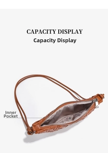 Detail view of the brown woven shoulder bag interior with capacity and inner pocket