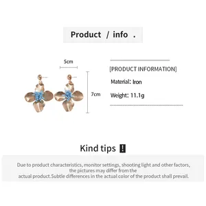 Detail view showing dimensions of vintage metal flower earrings 5cm width and 7cm height