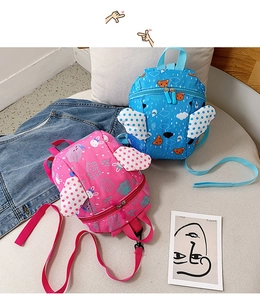 Detail of blue and pink toddler backpacks with 3D wings and smooth zipper closure