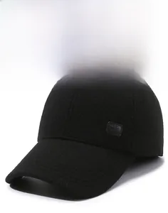 Detail view of winter baseball cap textured wool fabric and stitched leather logo patch