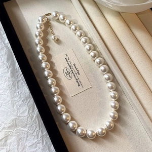 Detailed macro view of a French retro pearl necklace with lustrous white beads
