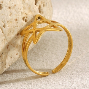 Macro detail of 18K gold plated stainless steel open ring with hollow star design