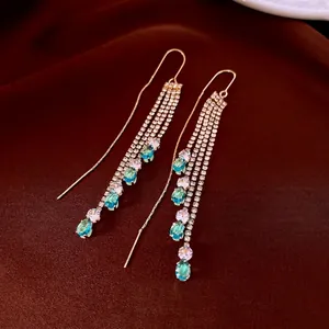 Luxurious gold-plated drop tassel earrings with blue water-drop stones on silk fabric