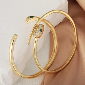 Luxurious gold-plated snake open bracelet set with sparkling green cubic zirconia eyes