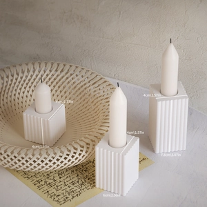 Detailed view of white ribbed square candle holder molds in three different sizes