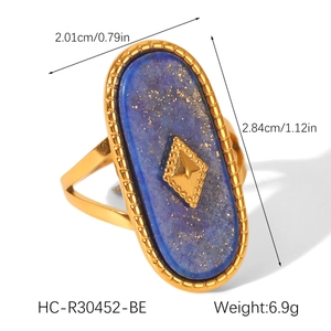 Detail of vintage 18K gold plated ring featuring oval blue stone and metallic inlay