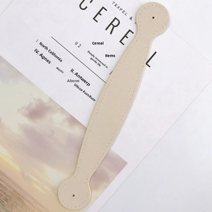 Detail of cream PU leather strap with neat stitching and round ends on a magazine