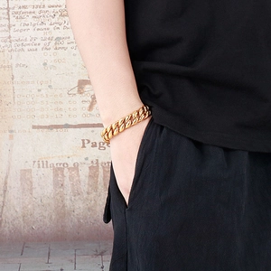 Men's bold 18k gold plated stainless steel Cuban link bracelet worn on wrist