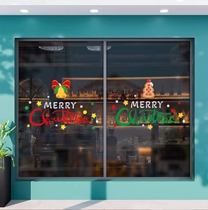 Close-up of Merry Christmas window stickers with festive bells and gingerbread tree motifs