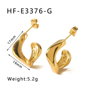 Detail view of gold irregular twisted C-shape earrings with internal textured surface