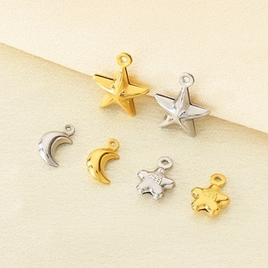 Detailed view of 18K gold and silver stainless steel star and moon pendants for DIY jewelry