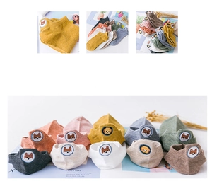 Flat lay of colorful cotton ankle socks featuring cute embroidered animal cartoon patterns