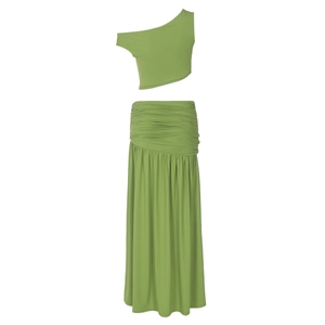 Detail view of grass green two-piece set featuring one-shoulder top and high-waist maxi skirt