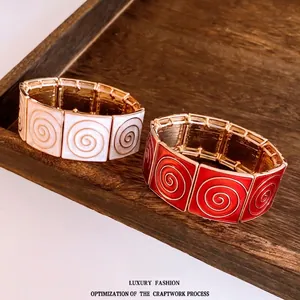 Vintage style elastic square bracelet with gold spiral texture in ivory and red