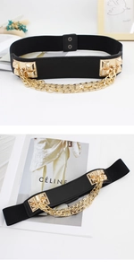 Detail of black elastic belt with golden pyramid studs and triple-layered metal chains